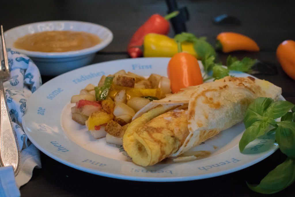 Classic Denver omelet with peppers, onions, cheddar cheese, and ham all wrapped in a flour tortilla. Served with sheep herder potatoes (diced potatoes, bell peppers, and onions) and an apple sauce cup.