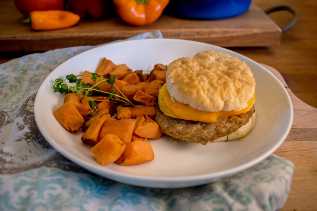 Individually wrapped sausage, egg, and cheese biscuit sandwich with diced roasted sweet potatoes.